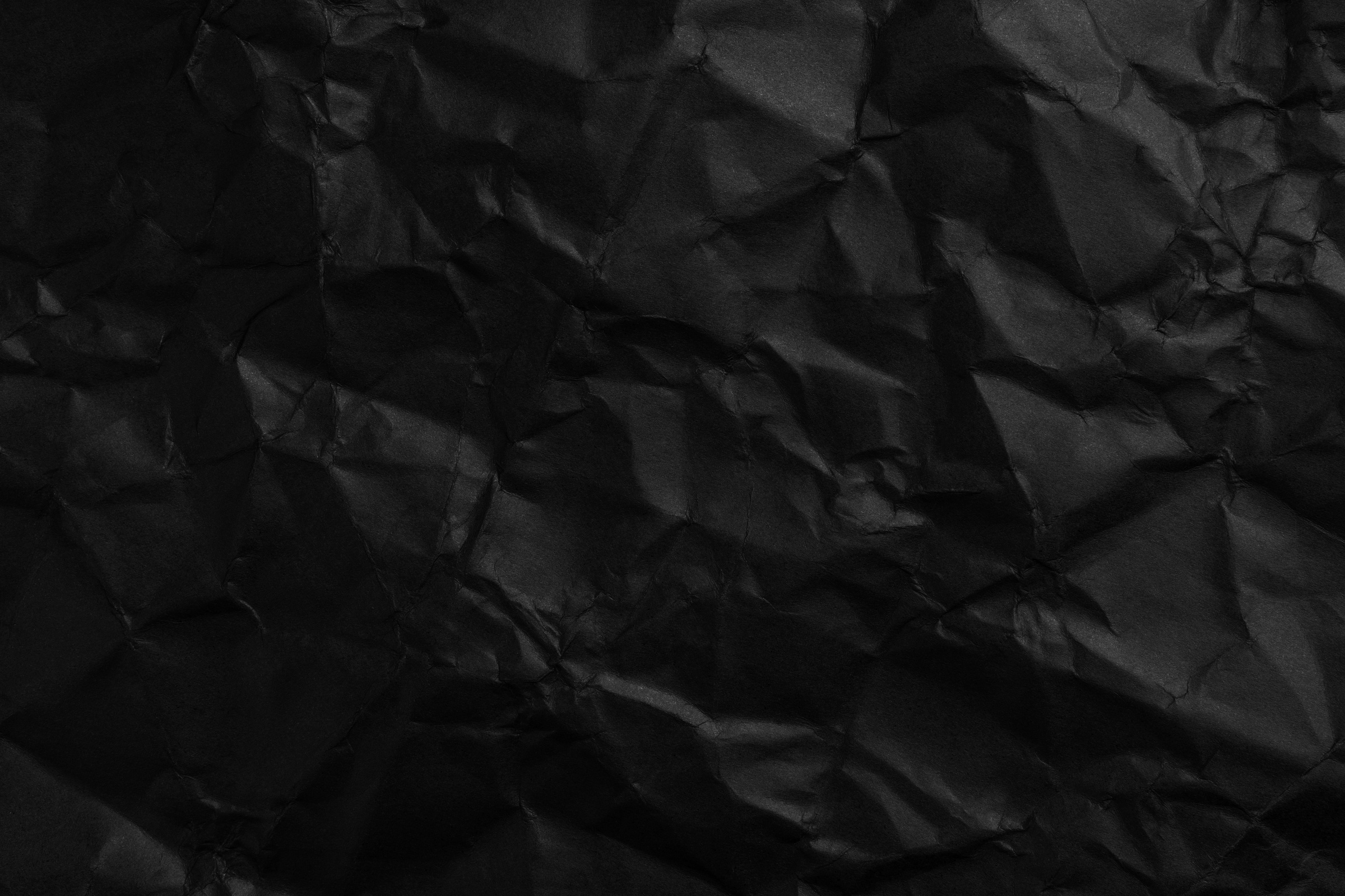Crumpled Black Paper Abstract Background